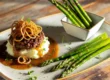 hamburger steaks topped with finely sliced caramelized onion sauce, served with a side of creamy mashed potatoes